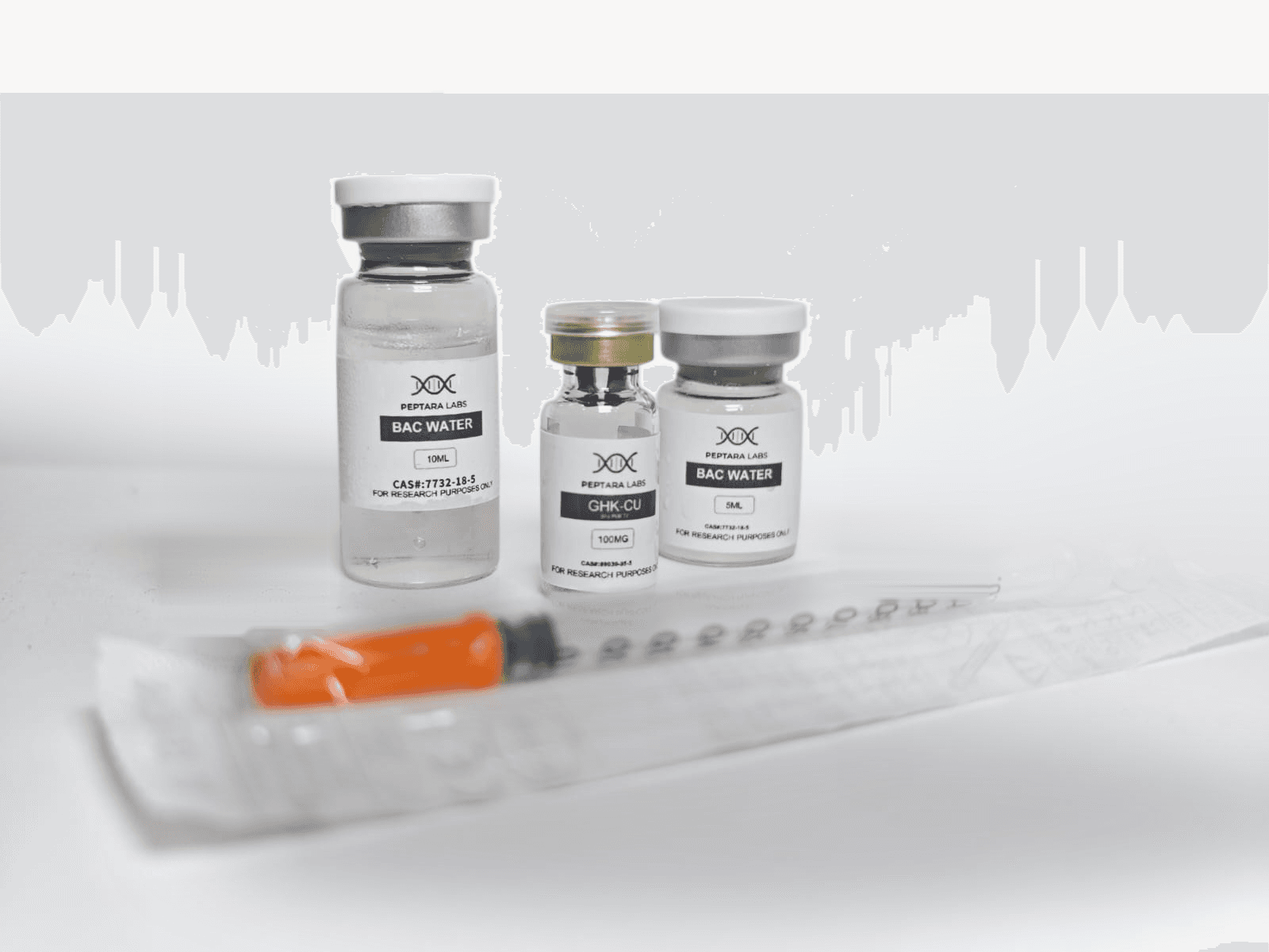 A Peptara Labs order laid out: a GHK-Cu vial, two bacteriostatic water vials and an insulin syringe