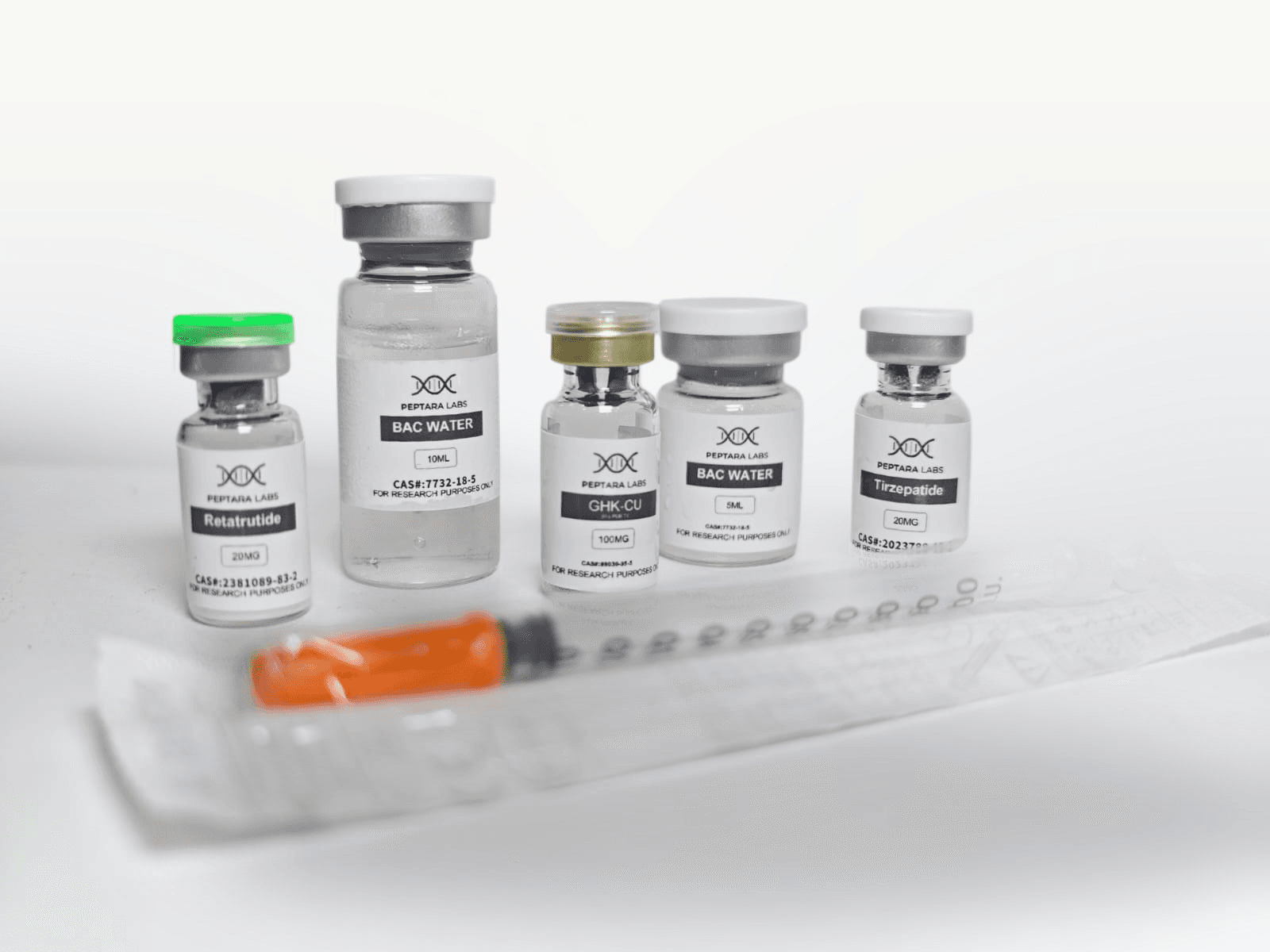 A Peptara Labs order laid out: peptide vials, bacteriostatic water, an insulin syringe and a storage container